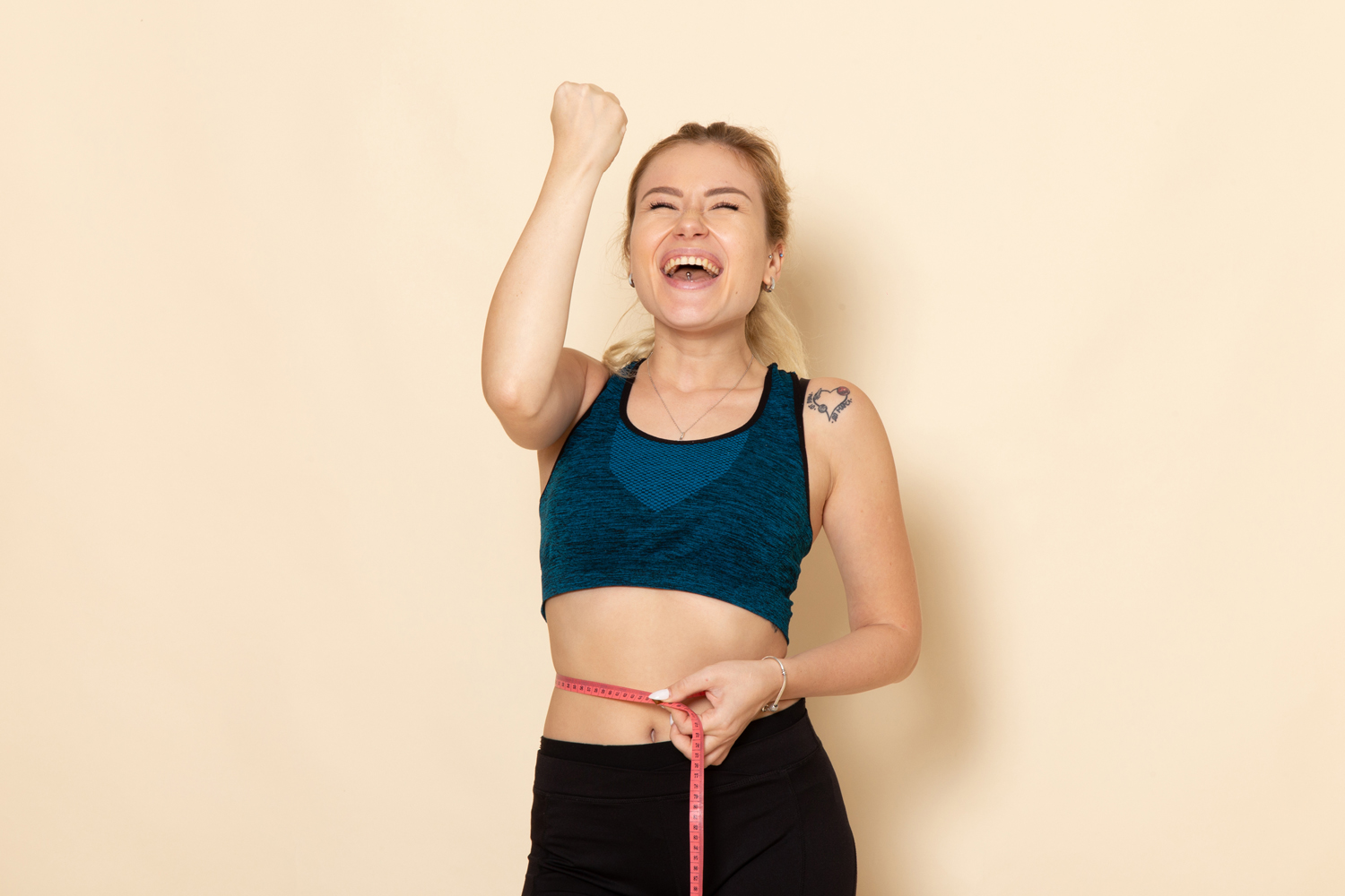 front view young female in sport outfit measuring her sizes and